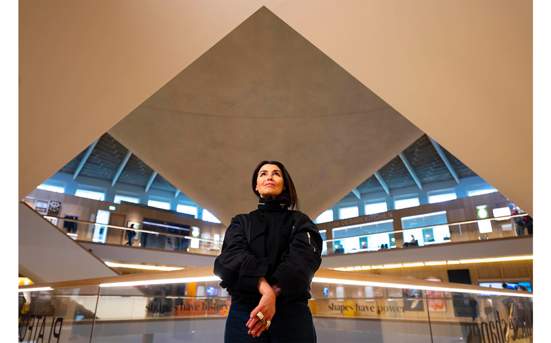 Es Devlin standing beneath the Design Museum's pyramidal roof, ahead of her October 2026 retrospective