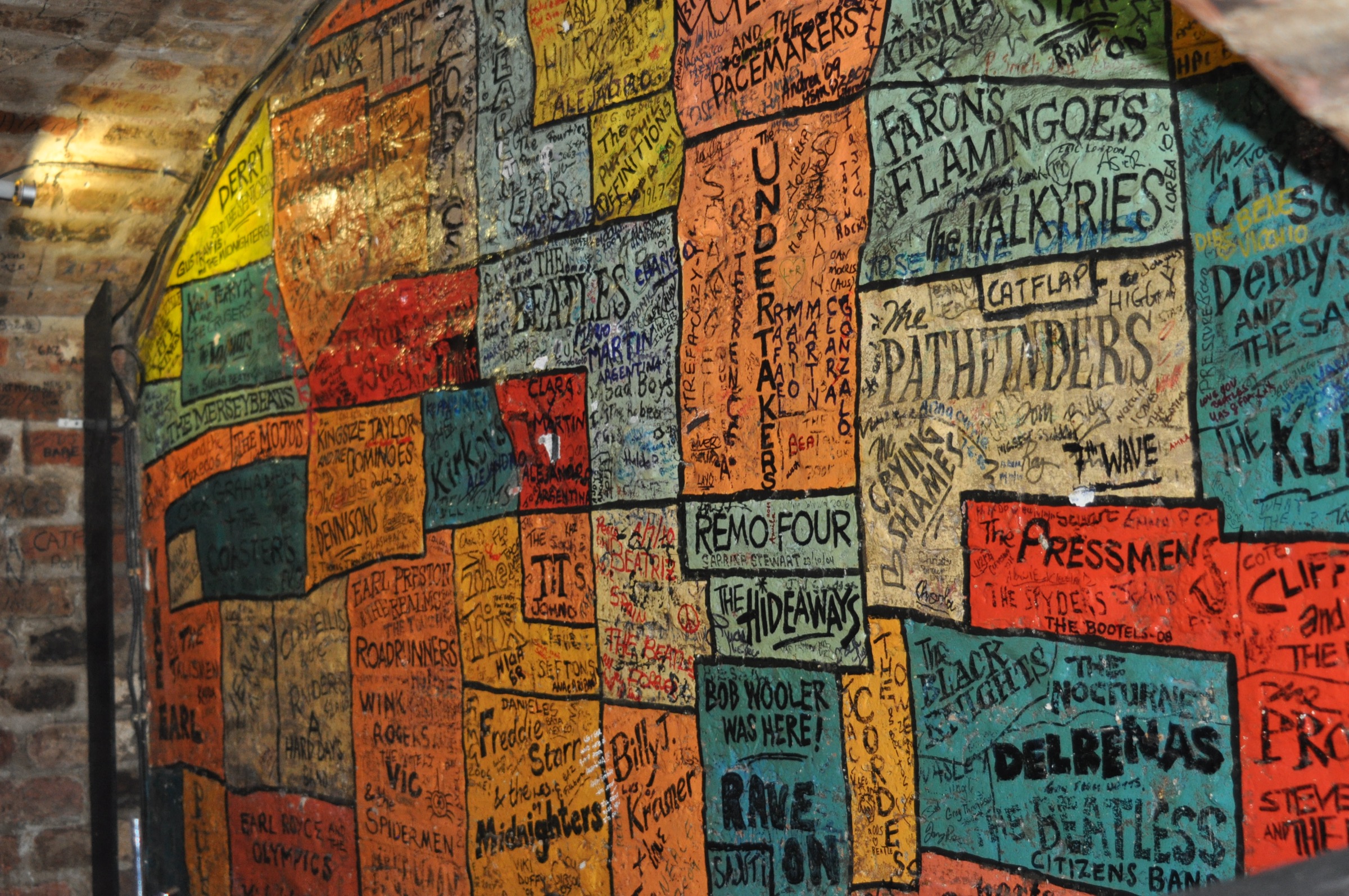 The painted wall of band names inside the Cavern Club, Liverpool, with The Beatles, Gerry and the Pacemakers, the Undertakers and dozens of other Merseybeat acts on colored panels