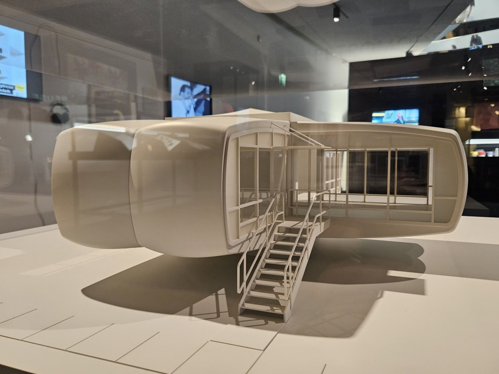 White scale model of the Monsanto House of the Future on a plinth in a museum gallery