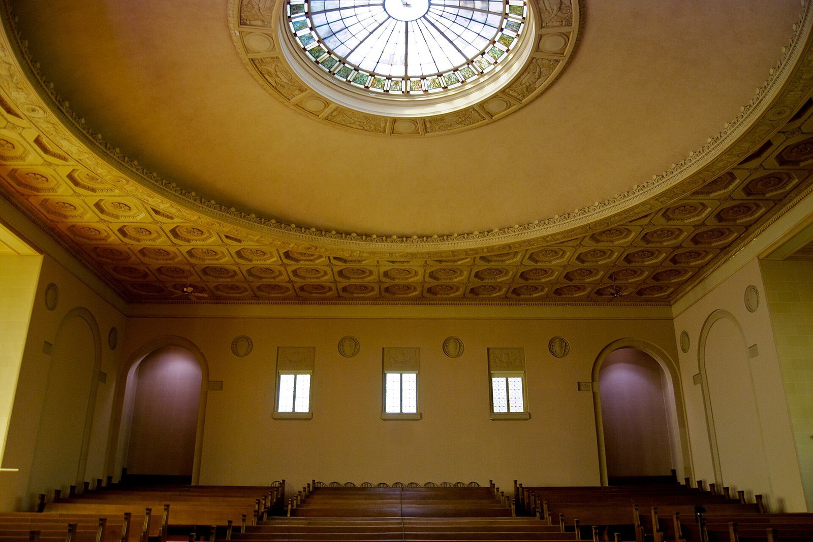 The domed former church sanctuary inside the Internet Archive building, with rows of wooden pews