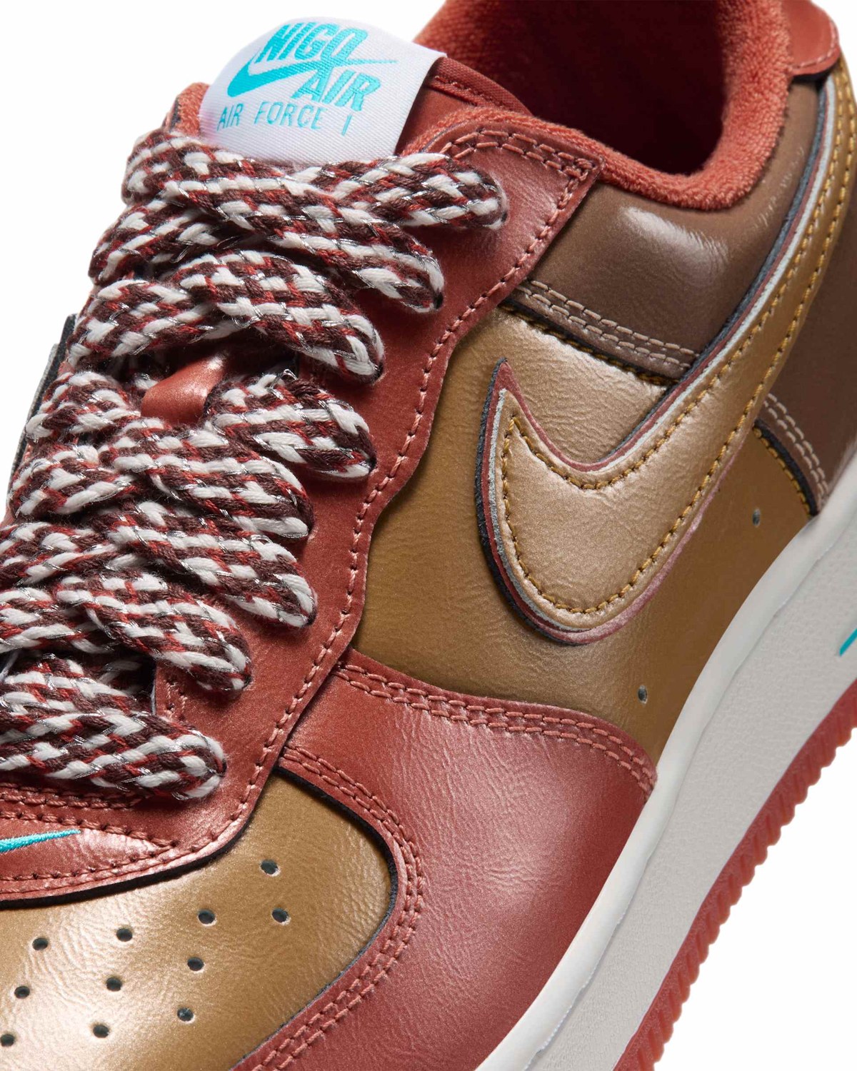 Close-up of the Nigo x j-hope Air Force 1 '01 in brown and rust leather, with a tongue tag reading NIGO AIR